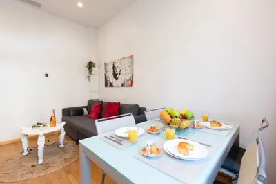 a living room with a table with food on it at Pelige 5 YourHostHelper in Cannes