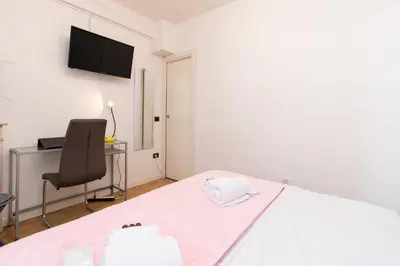 a bedroom with a bed and a desk and a chair at Pelige 3 YourHostHelper in Cannes