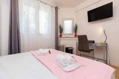 a bedroom with a bed with two baby dolls on it at Pelige 3 YourHostHelper in Cannes