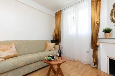 a living room with a couch and a table at Pelige 3 YourHostHelper in Cannes