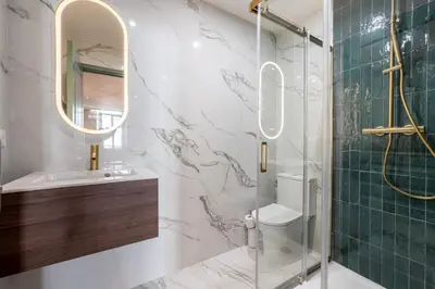 a bathroom with a shower and a sink and a mirror at Bel appartement centre Cannes 1min de la Croisette in Cannes