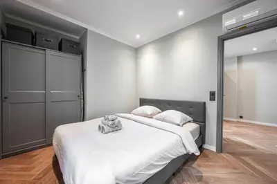 a bedroom with a bed and a large mirror at Bel appartement centre Cannes 1min de la Croisette in Cannes