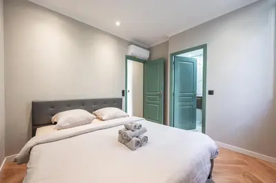 a bedroom with a bed with a teddy bear on it at Bel appartement centre Cannes 1min de la Croisette in Cannes