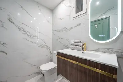 a bathroom with a sink and a mirror at Bel appartement centre Cannes 1min de la Croisette in Cannes