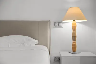a lamp on a night stand next to a bed at Cannes Croisette 2 bedrooms - 7C3 in Cannes
