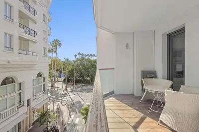 a balcony of a building with a table and chairs at Cannes Croisette 2 bedrooms - 7C3 in Cannes