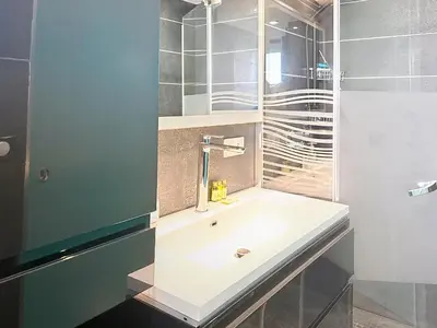 a bathroom with a sink and a mirror at Stylish 1-bedroom apartment with sea view on La Croisette in Cannes