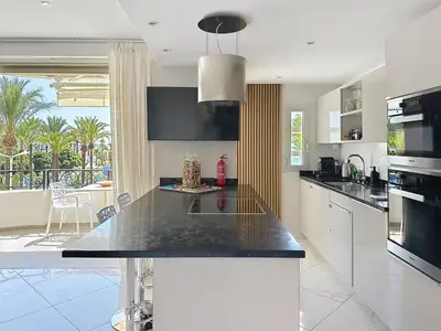 a kitchen with a large island with a counter top at Stylish 1-bedroom apartment with sea view on La Croisette in Cannes