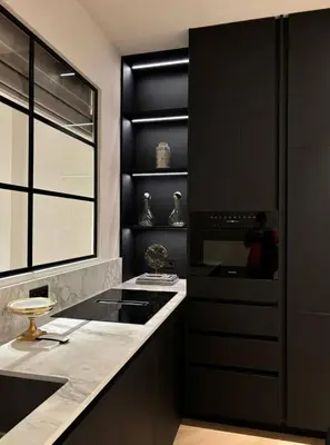 a kitchen with black cabinets and a counter top at Cannes 1 bedroom apartment - M1 in Cannes