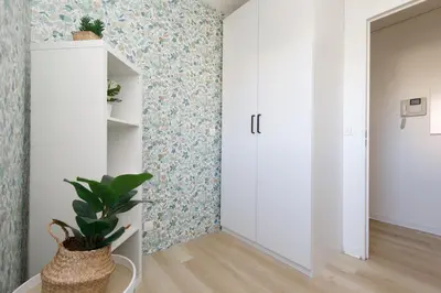 a hallway with a door and a plant in a room at Immogroom - Warm T2 - AC - Wifi - Comfort in Cannes