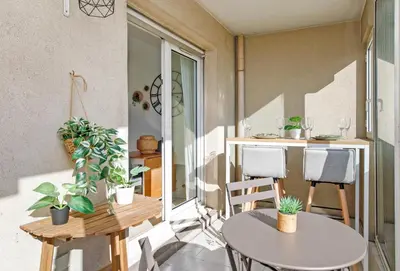 a small balcony with a table and chairs at Immogroom - Warm T2 - AC - Wifi - Comfort in Cannes