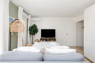 a living room with two couches and a tv at Immogroom - Warm T2 - AC - Wifi - Comfort in Cannes
