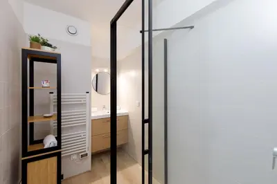 a bathroom with a mirror and a sink at Immogroom - Warm T2 - AC - Wifi - Comfort in Cannes