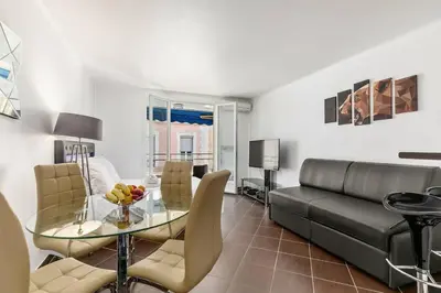 a living room with a couch and a glass table at Luxury Studio YourHostHelper in Cannes
