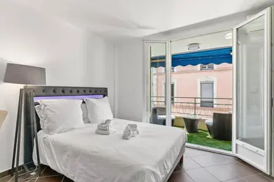 a bedroom with a bed and a large window at Luxury Studio YourHostHelper in Cannes