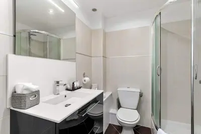 a bathroom with a toilet and a sink and a shower at Luxury Studio YourHostHelper in Cannes