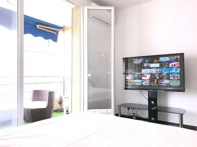 a bedroom with a flat screen tv on a wall at Luxury Studio YourHostHelper in Cannes