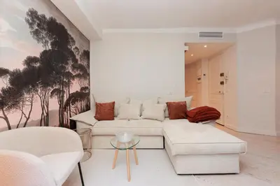 a living room with a white couch and chairs at Perrissol YourHostHelper in Cannes