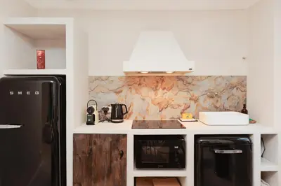 a kitchen with a black refrigerator and a microwave at Perrissol YourHostHelper in Cannes
