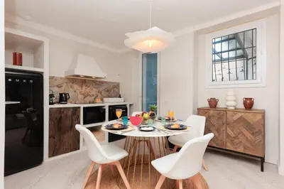 a dining room with a table and chairs in a kitchen at Perrissol YourHostHelper in Cannes