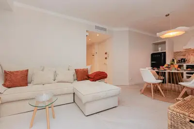 a living room with a white couch and a table at Perrissol YourHostHelper in Cannes