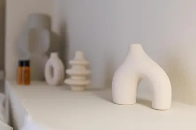 a white vase sitting on a shelf with other vases at Cannes banana apartment in Cannes