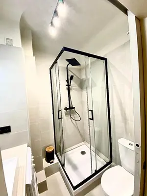 a glass shower in a bathroom with a toilet at Cannes banana apartment in Cannes
