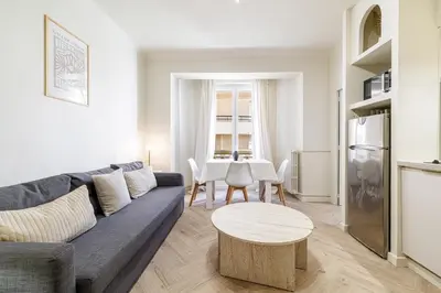 a living room with a couch and a table at Cannes banana apartment in Cannes