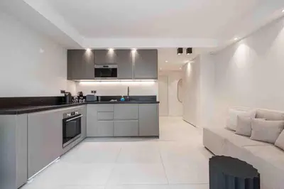 a kitchen and living room with a couch and a table at Pasteur Luxury apartment la Croisette in Cannes