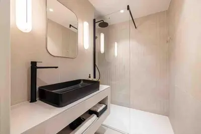 a bathroom with a black sink and a mirror at Pasteur Luxury apartment la Croisette in Cannes