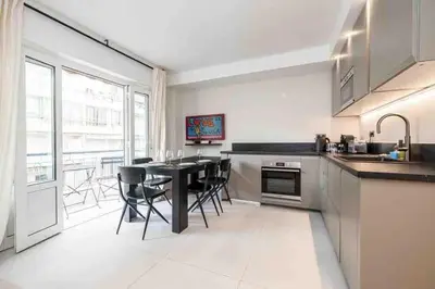 a kitchen with a table and some chairs in it at Pasteur Luxury apartment la Croisette in Cannes