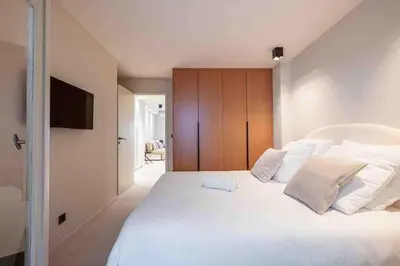 a bedroom with a large white bed with white pillows at Pasteur Luxury apartment la Croisette in Cannes