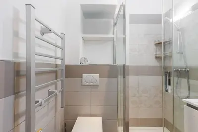 a small bathroom with a shower and a toilet at Villa Mimosa - Cannes in Cannes