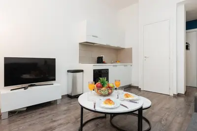 a living room with a table with a bowl of fruit at Villa Mimosa - Cannes in Cannes