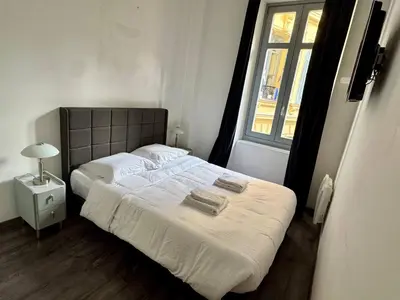 a bedroom with a bed with two towels on it at Villa Mimosa - Cannes in Cannes
