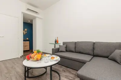 a living room with a couch and a table at Villa Mimosa - Cannes in Cannes
