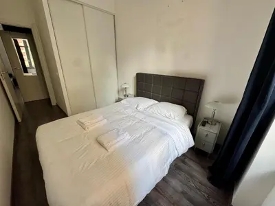 a bedroom with a large bed with white sheets at Villa Mimosa - Cannes in Cannes