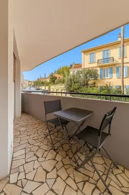 a table and chairs on a balcony with a view at La Suite du Festival in Cannes