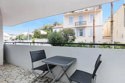 two chairs and a table on a balcony at La Suite du Festival in Cannes