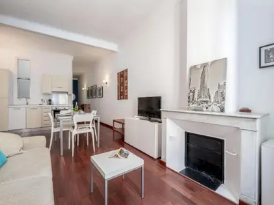 a living room with a couch and a fireplace at Apartment rue des Serbes by Interhome in Cannes