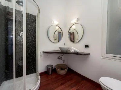 a bathroom with a shower and a sink and mirrors at Apartment rue des Serbes by Interhome in Cannes