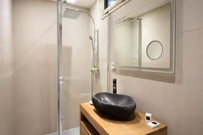 a bathroom with a black sink and a shower at One bedroom apartment with beautiful sea view in Cannes