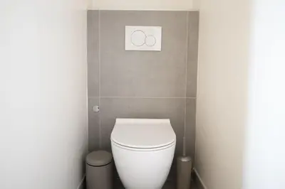 a bathroom with a toilet with two rings on the wall at One bedroom apartment with beautiful sea view in Cannes