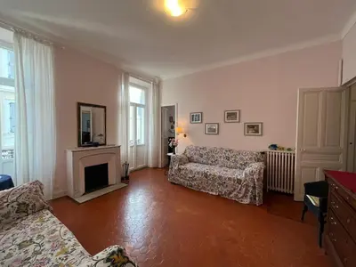 a living room with a couch and a fireplace at A005 Spacious and bright apt close to Croisette in Cannes