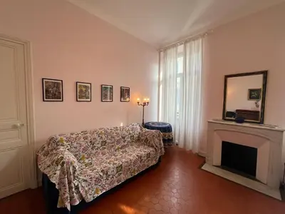a living room with a bed and a fireplace at A005 Spacious and bright apt close to Croisette in Cannes