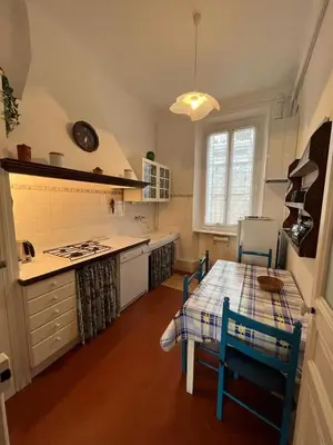 a kitchen with a table and a table and chairs at A005 Spacious and bright apt close to Croisette in Cannes