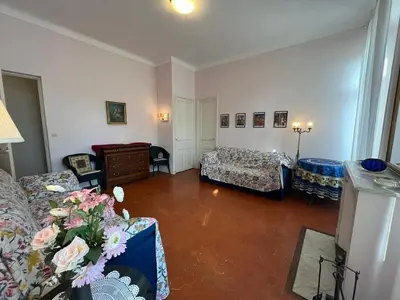 a living room with two couches and a room with flowers at A005 Spacious and bright apt close to Croisette in Cannes
