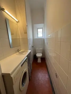 a bathroom with a toilet and a sink and a washing machine at A005 Spacious and bright apt close to Croisette in Cannes