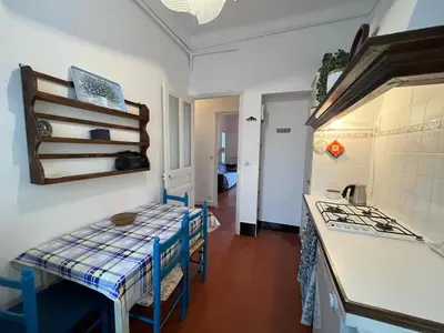 a kitchen with a table and a stove top oven at A005 Spacious and bright apt close to Croisette in Cannes