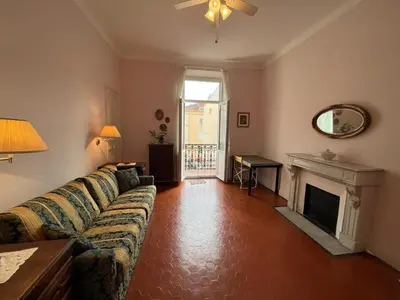a living room with a couch and a fireplace at A005 Spacious and bright apt close to Croisette in Cannes